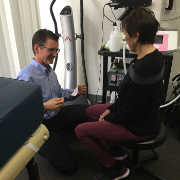 Dr. Olsen performing an ACG, acoustic cardiograph, on a patient in one of our therapy rooms where we also do vibration plate therapy, shockwave or acoustic wave therapy, PEMF of pulsed electromagnetic field therapy, PNOE metabolic and VO2 Max testing, and balance tracking testing.