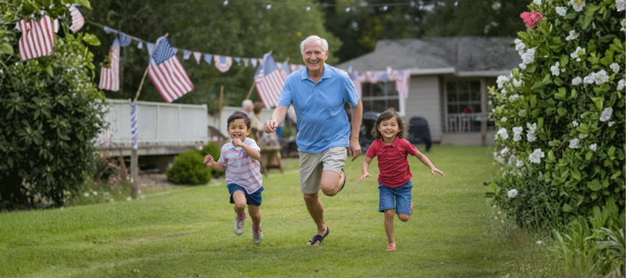 Senior man running and smiling in a backyard with a little boy and girl